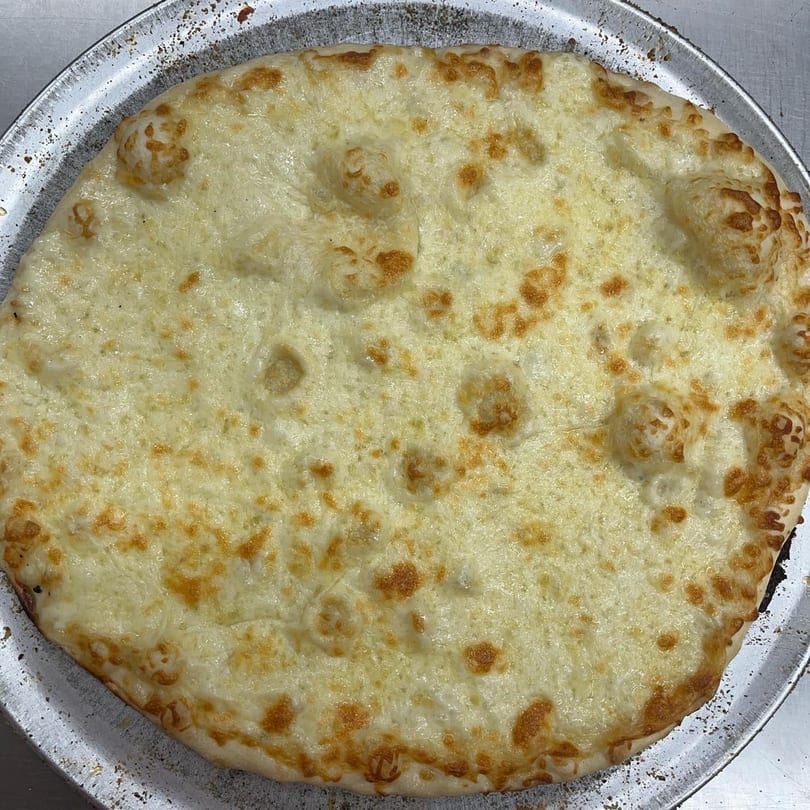 Jake's Pizza Rostraver's cheese pizza, golden brown and bubbly, on a metal pizza pan.